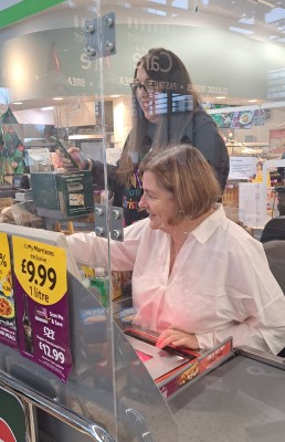 Sharon Shaw, Corporate Parenting Service Manager and Alex, Morrisons Leamington Community Champion, managing the checkout!